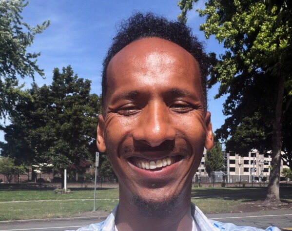 Ali Abdulla, the founder and executive director of the nonprofit African Youth Sports Academy, poses for a self-portrait outside his Seattle office on Friday, June 12, 2026. (Ali Abdulla via AP)